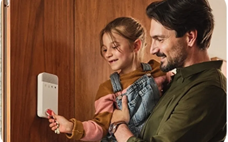 Isä ja tytär käyttävät käyttönäppäimistöä avaimenperätunnisteella.